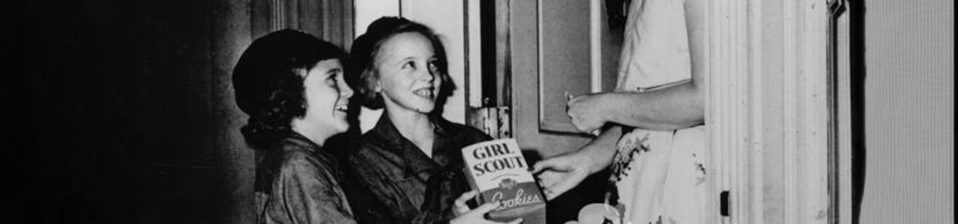 historical image of girls holding cookie box