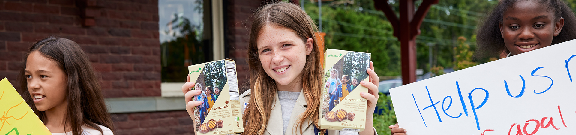  girl scout staff or volunteer wearing adult vest in woods smiling 