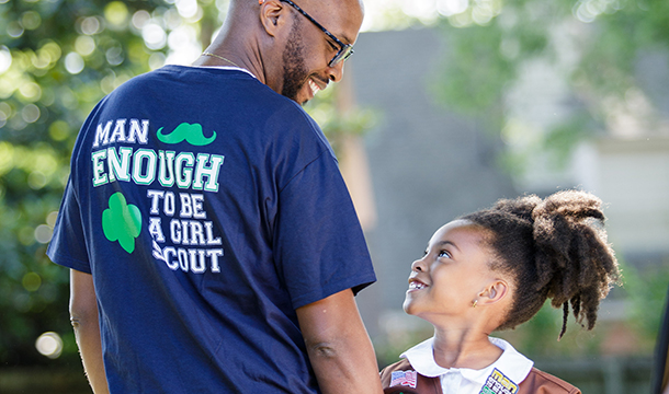 father and daughter looking at one another holding Man Enough patch